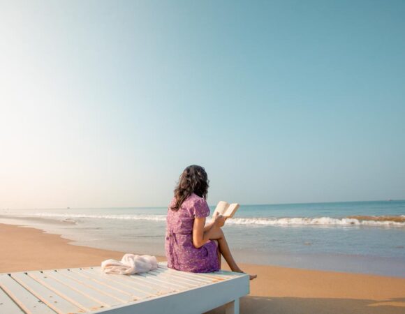 girl reading in a beach kerala