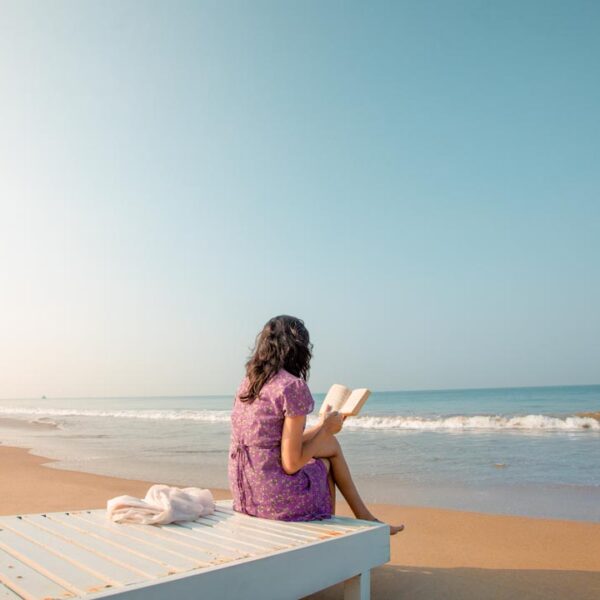 girl reading in a beach kerala