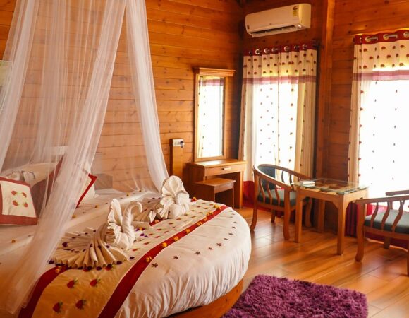 bedroom of Waterfront Royale cottage in Lakerose Wayanad resort